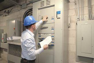 electrician working on an industrial electrical panel